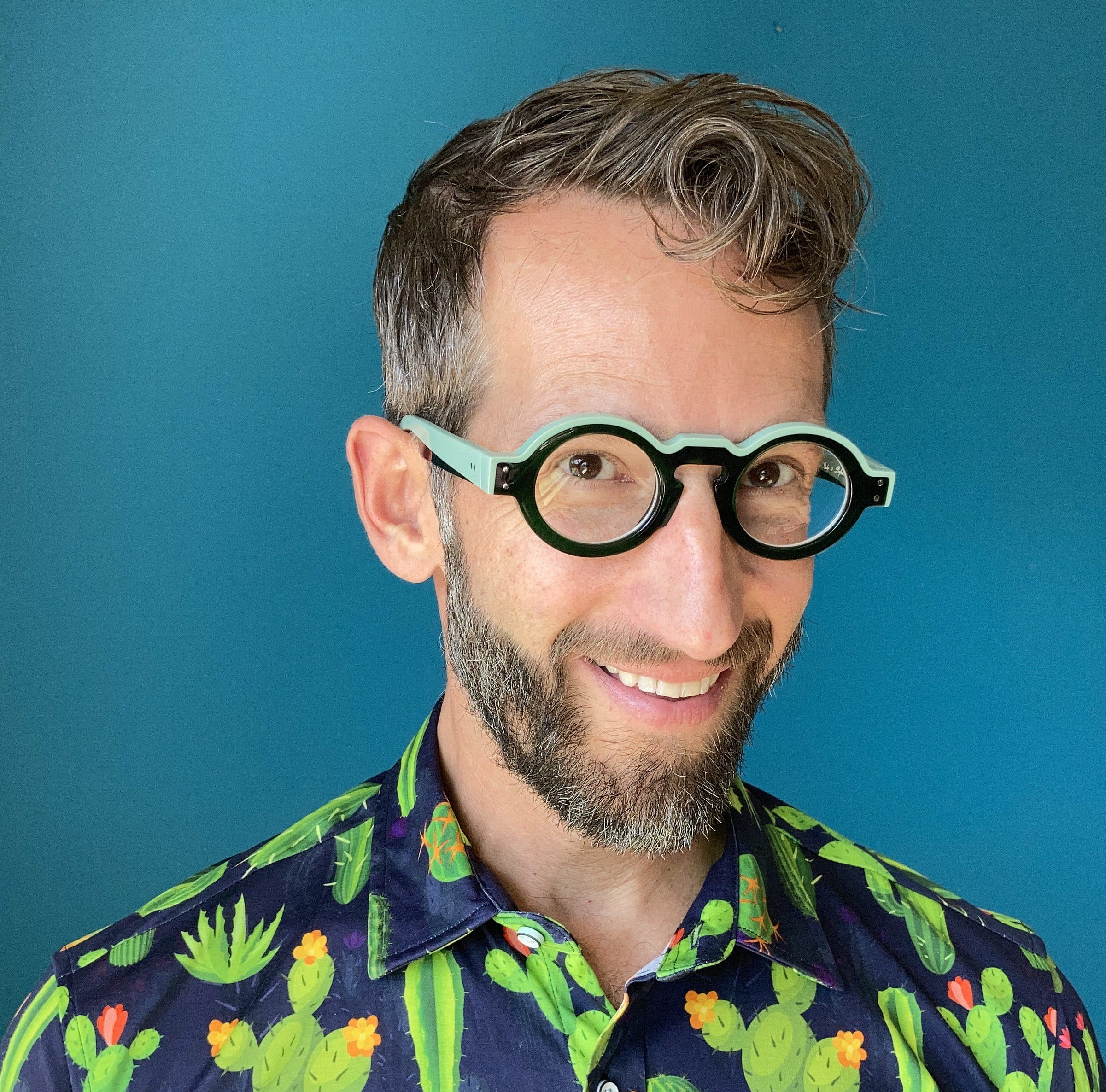 Actor Alexis Baigue, set against a blue background.
